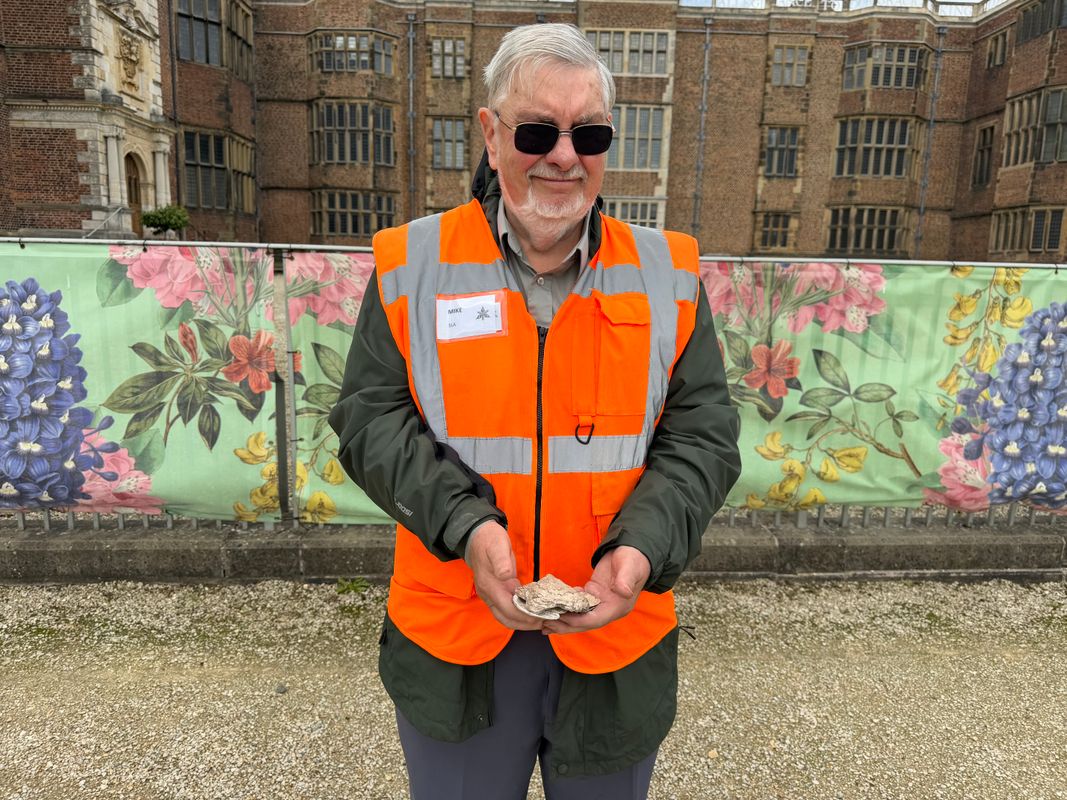 Mike Turpin from South Leeds Archaeology (SLA) holding animal bones and oyster shells from the house’s former kitchens in front of Temple Newsam House