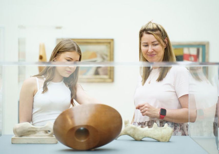 two people look at a sculpture 