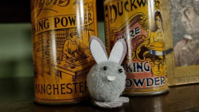 A felt bunny hidden amongst some pots at Abbey House Museum