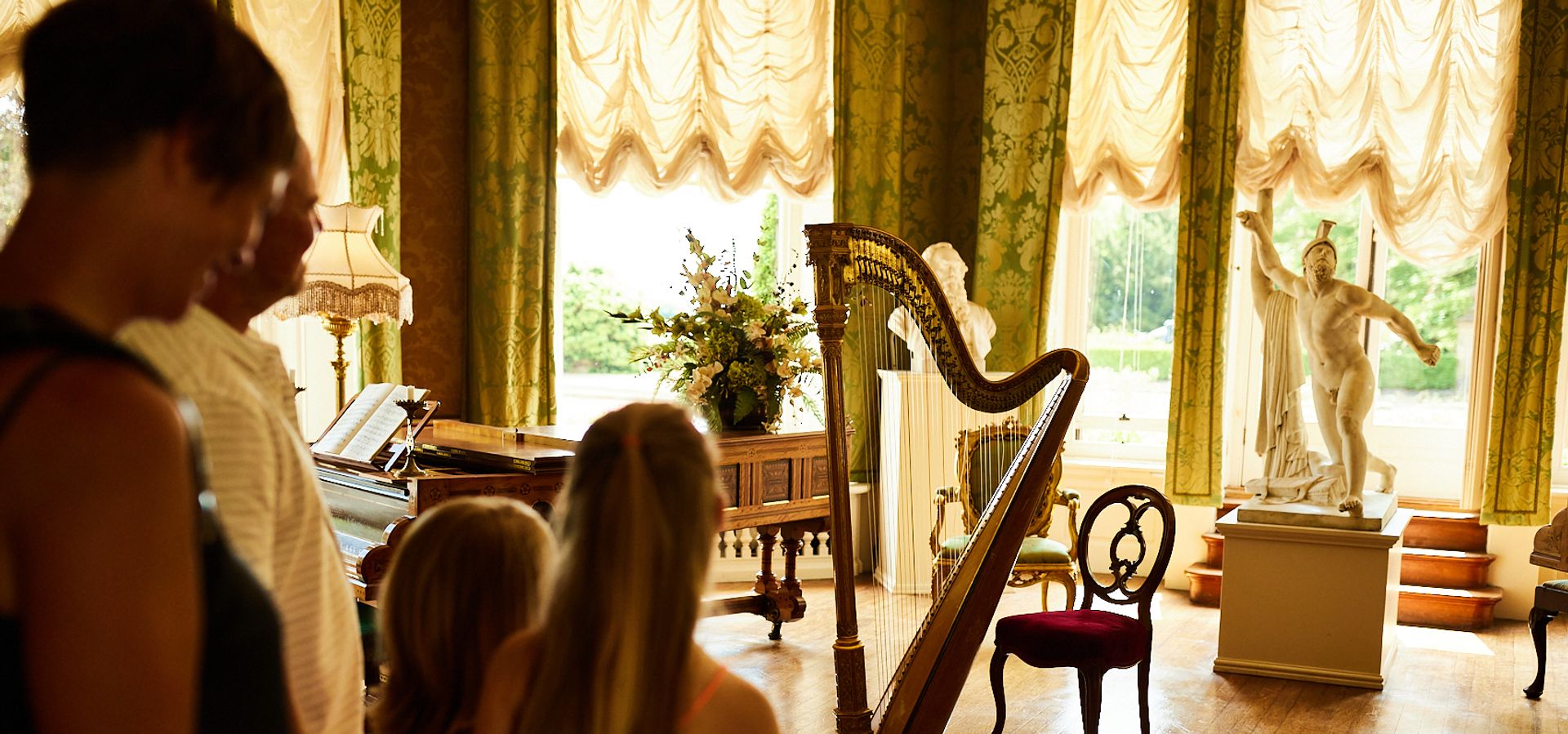 A family looking at a drawing room in Lotherton Hall