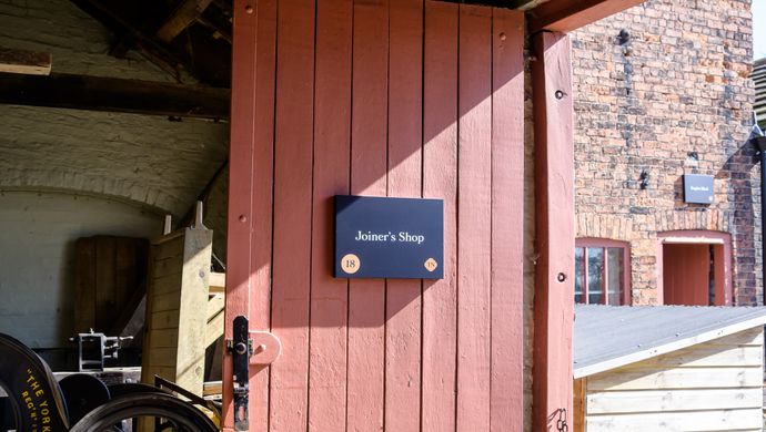 Red door at Home Farm with a sign saying Joiners Shop