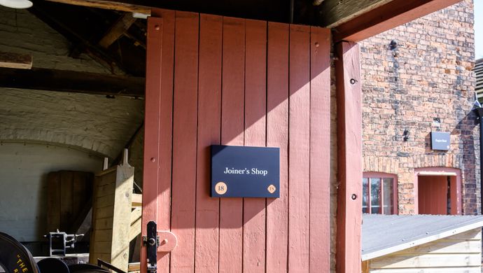 Red door at Home Farm with a sign saying Joiners Shop