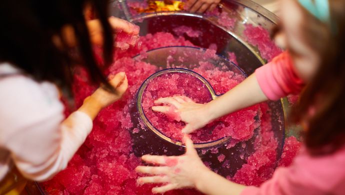 Children playing with a red goo activity