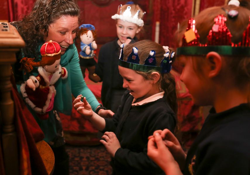 image of practitioner with puppets engaging children in a workshop