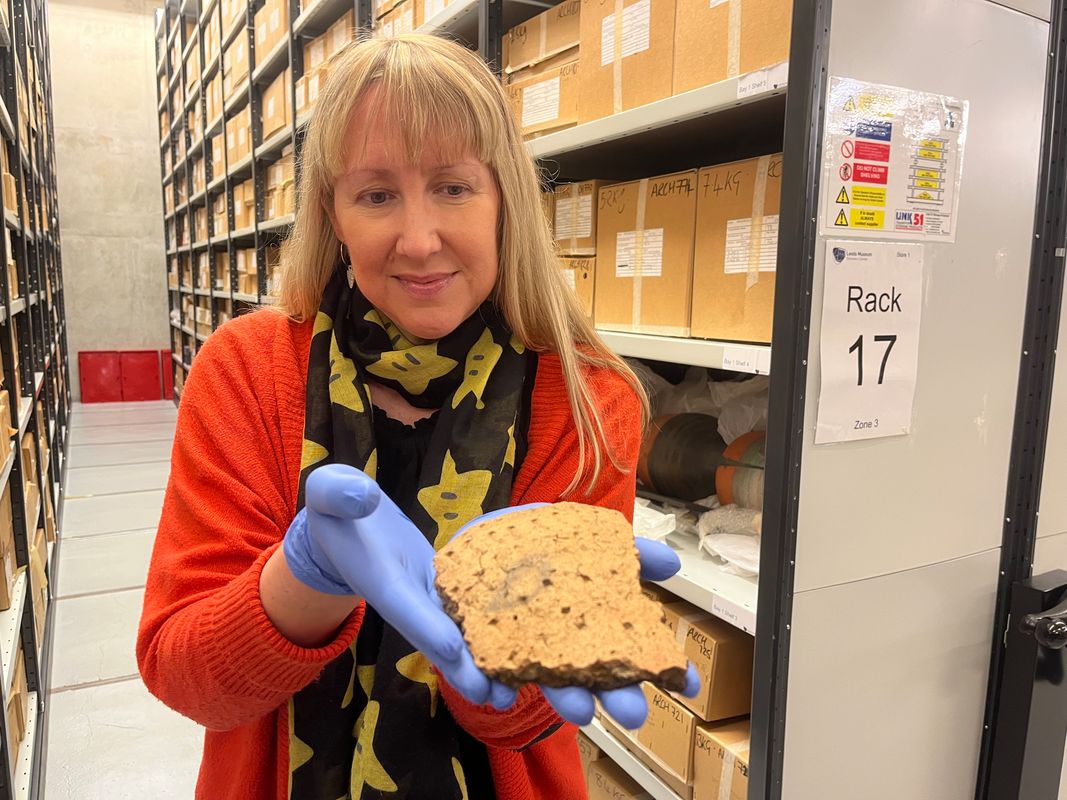 Kat Baxter, Leeds Museums and Galleries’ curator of archaeology, with fragments of a decorated clay urn found at Pitty Close Farm in Leeds