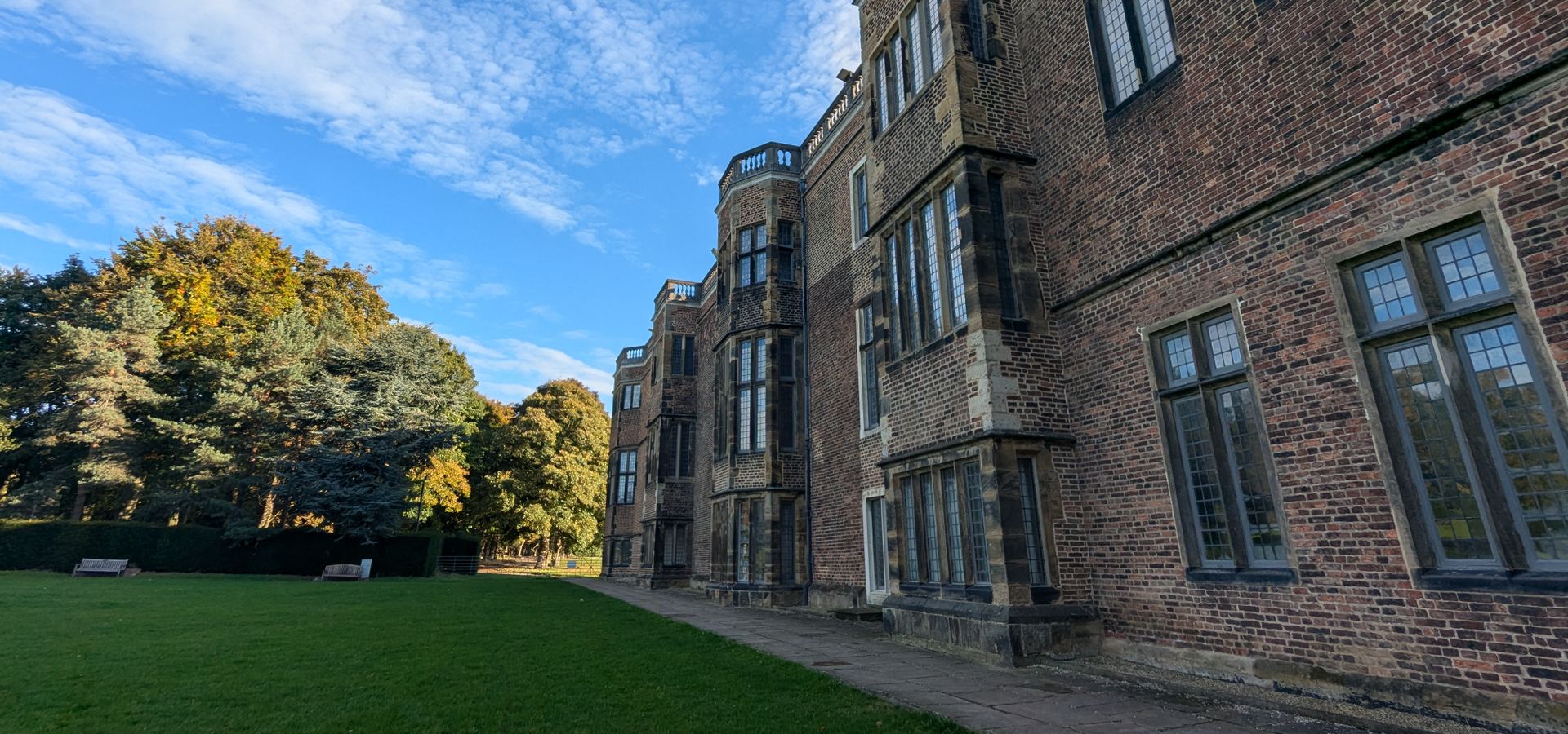 A landscape image of Temple Newsam house on the right and gardens on the left.