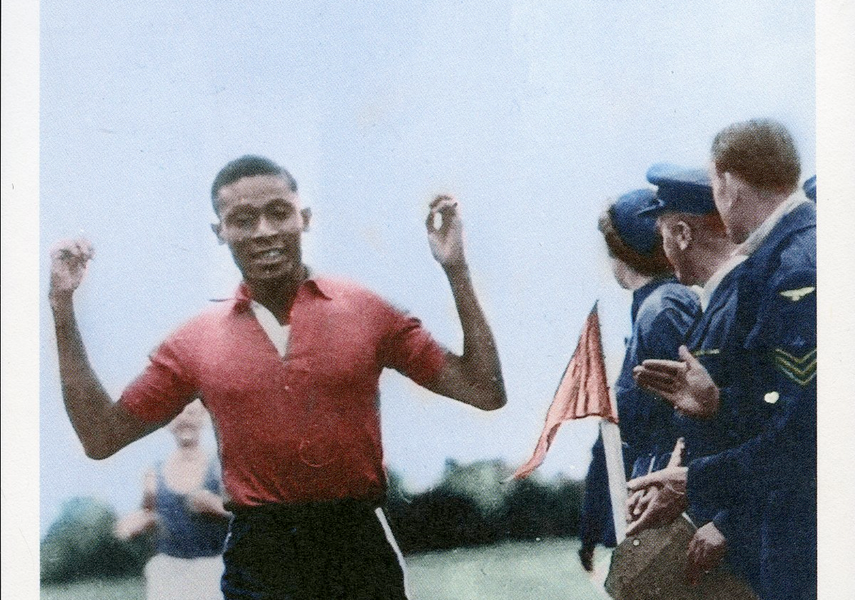 Man in running gear crossing a finish line