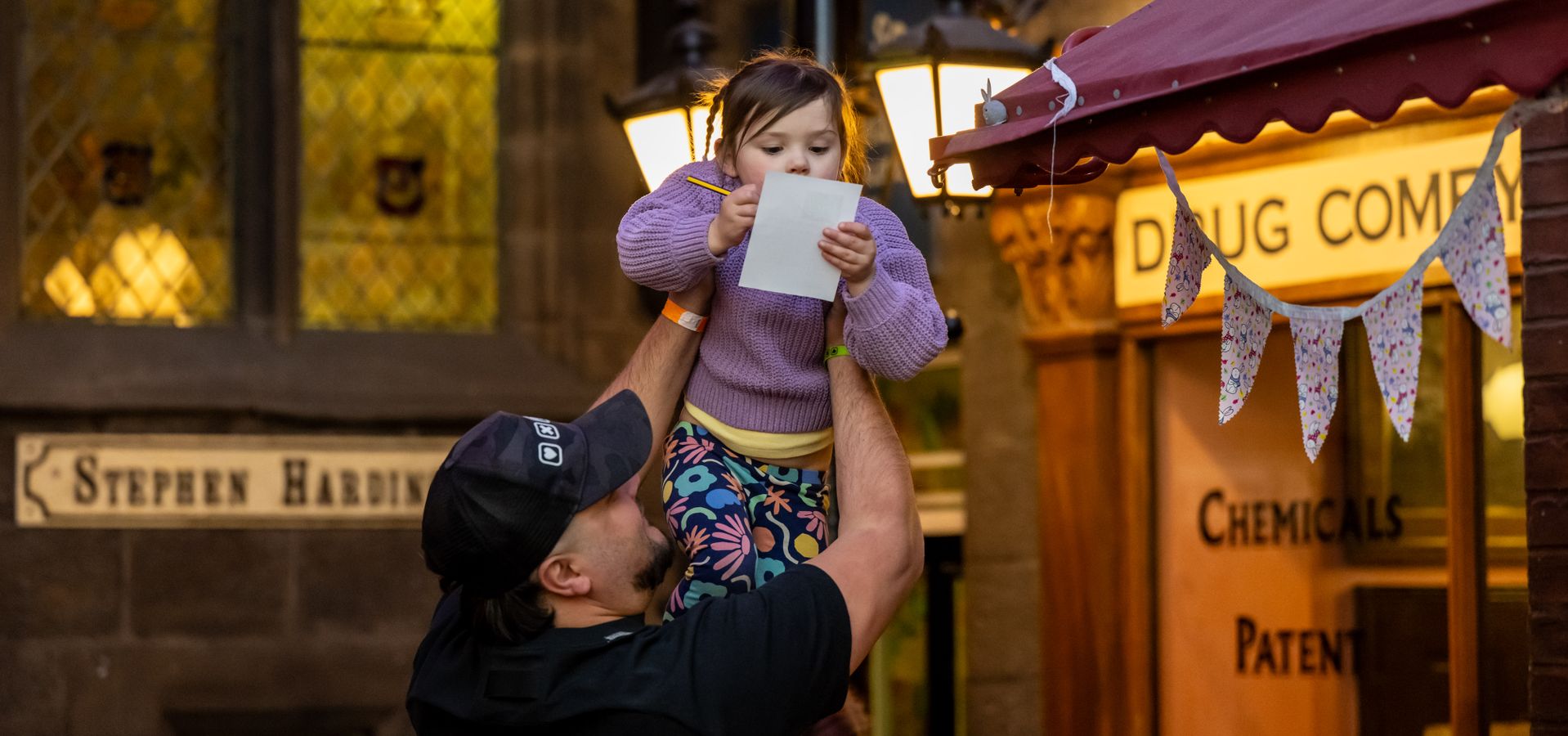 A child being held up by an adults