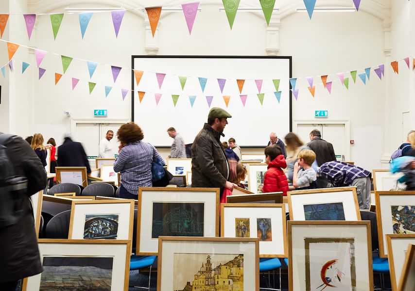 People looking at frames artwork