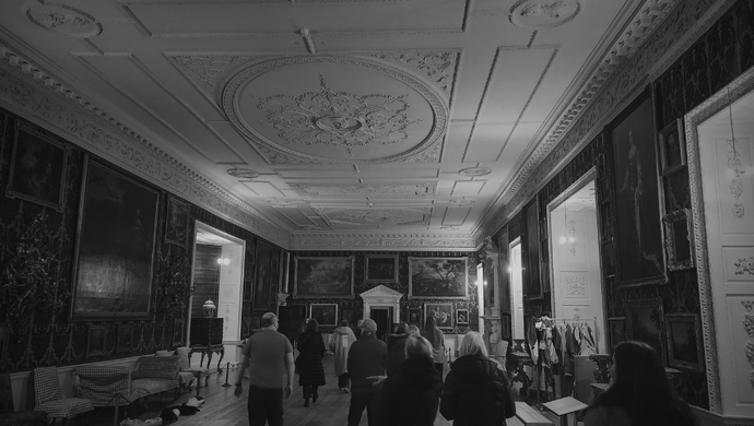 A dark image of a tour in the picture gallery at Temple Newsam