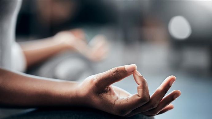 A hand resting on a persons thigh