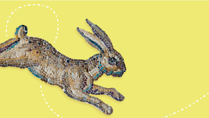 A mosaic rabbit on a yellow background with a white dotted trail to follow
