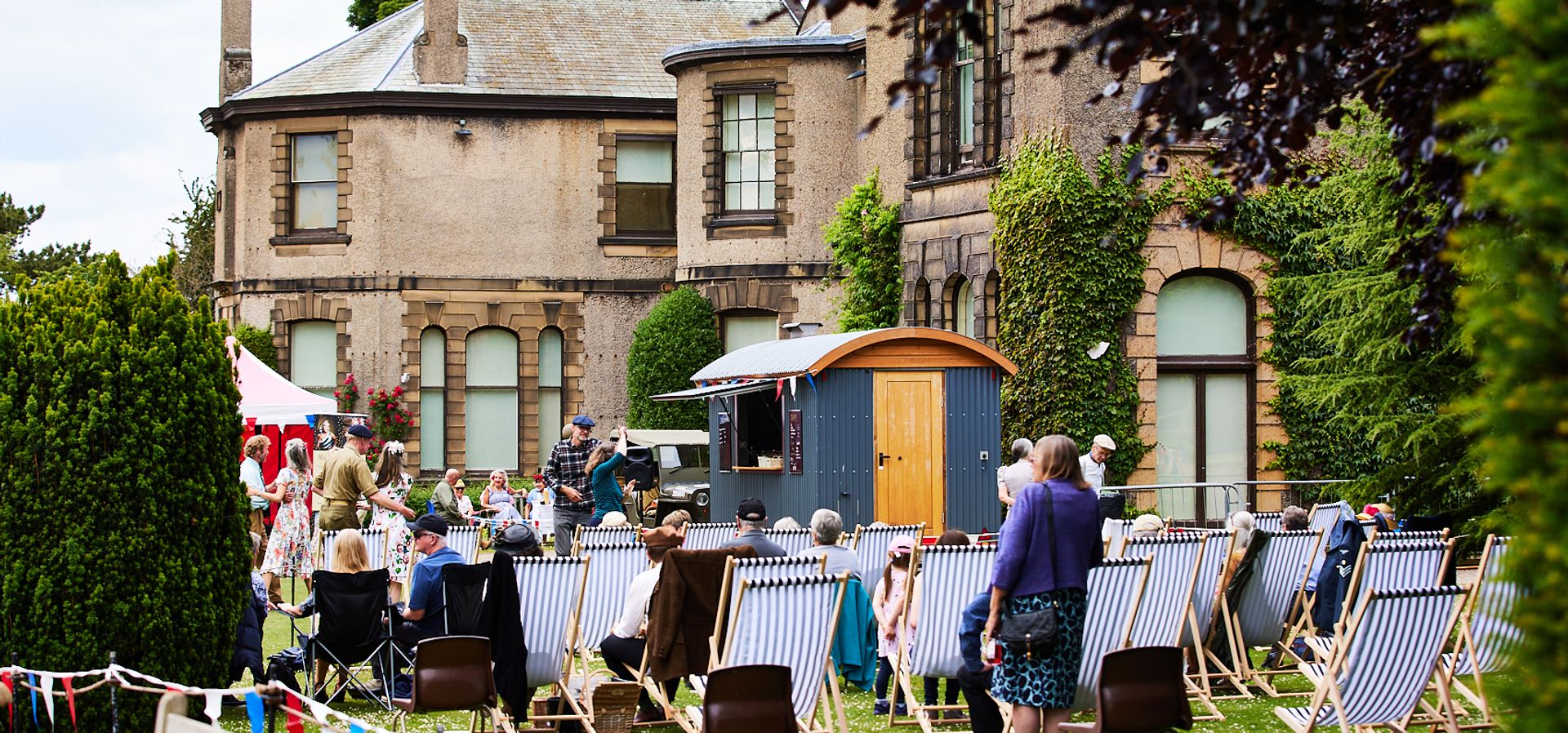 Families sat on seats outside Lotherton in the gardens