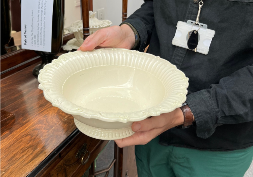 A large ceramic bowl in the hands of a staff member at Leeds Discovery Centre