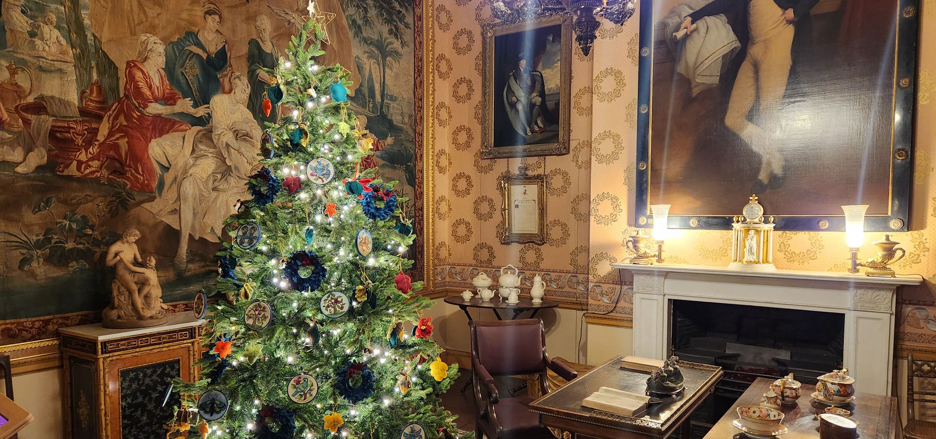 A light up christmas tree with small tapestries on