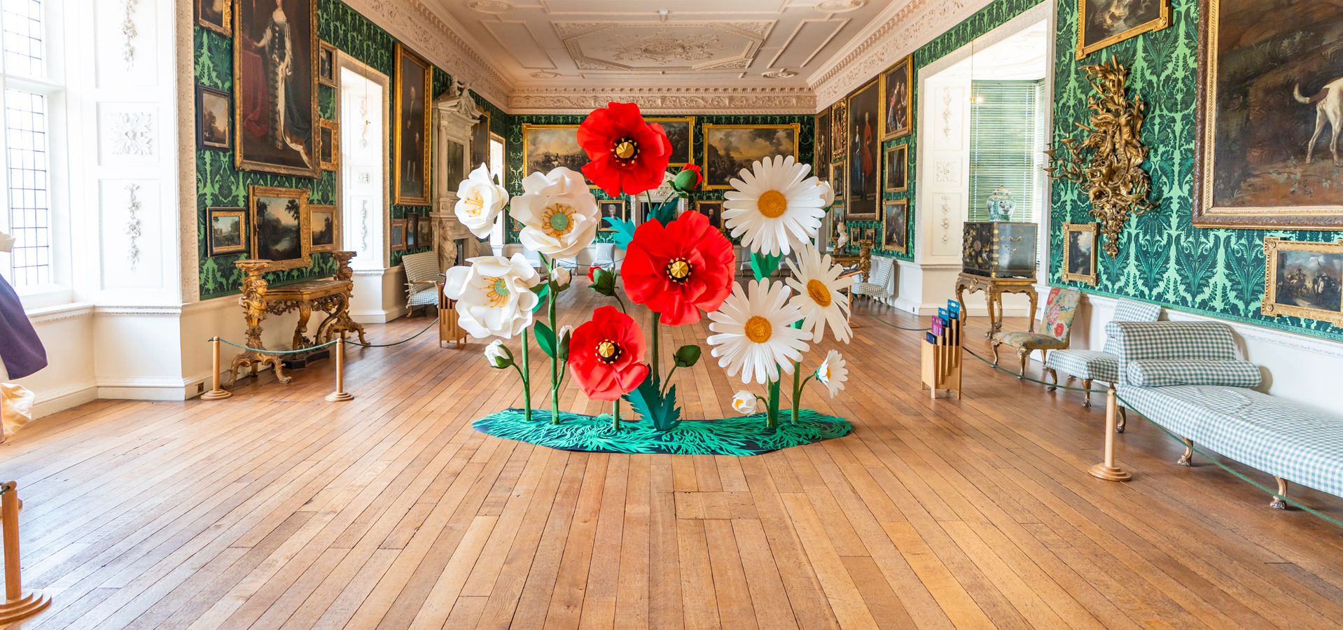 A flower sculpture with 3 red poppies, 3 daisies and 3 white flowers in The Picture Gallery