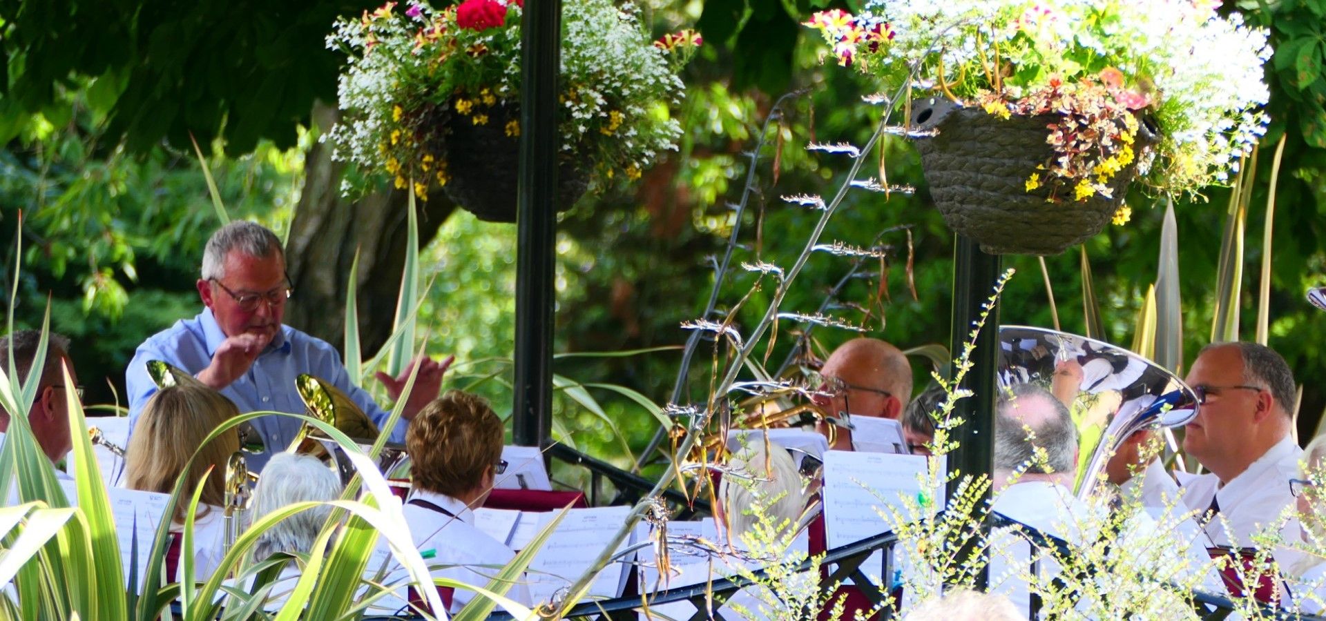 Summer band playing in the outdoors surrounded by flowers
