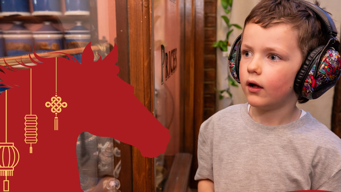 A child in headphone looking around Victorian streets with a red horse illustration on top