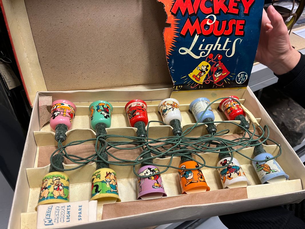 a set of Mickey Mouse Christmas tree lights as well as some brightly coloured glass baubles manufactured by Morley’s Briteglass Ltd