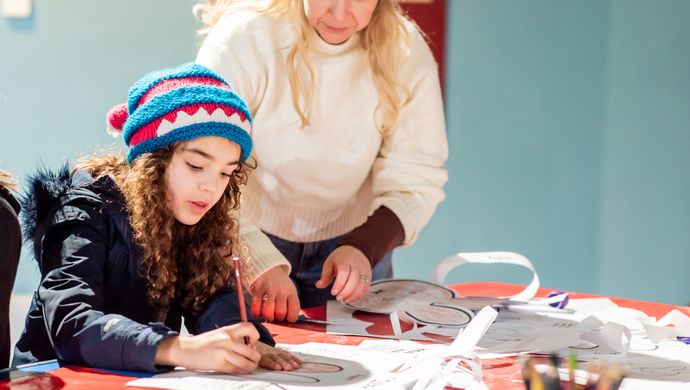 A child and parent taking part in craft activities at the museum