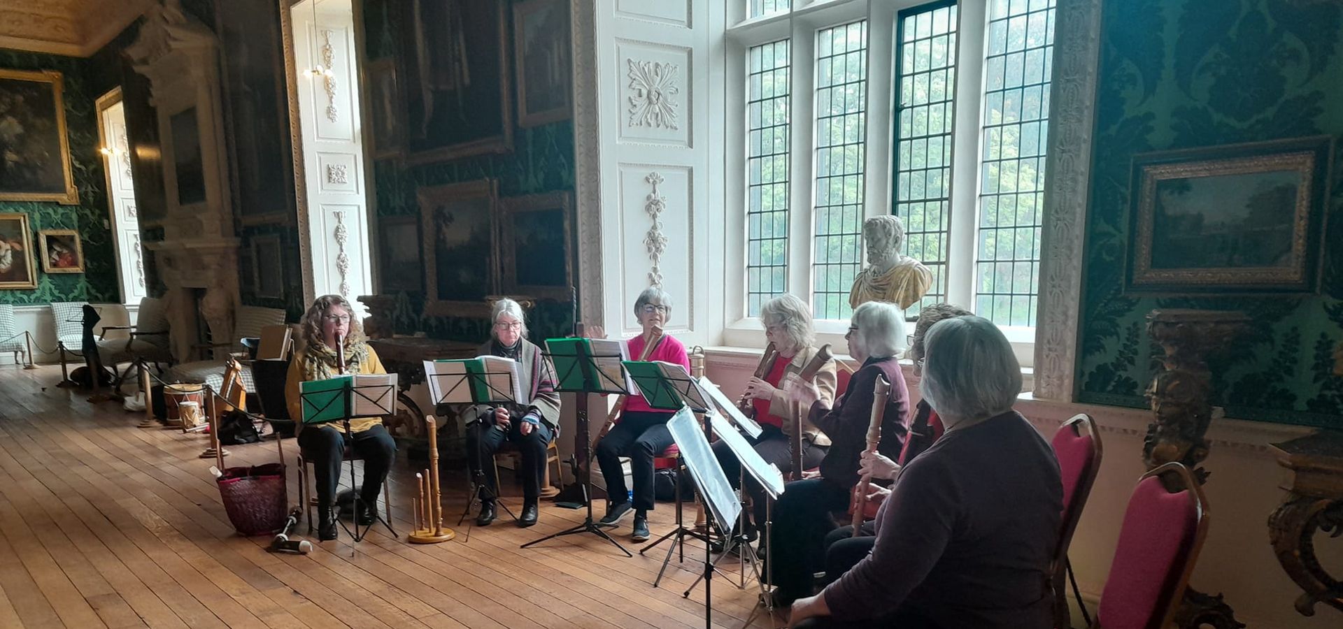 A group of musicians playing inside The Picture Gallery at Temple Newsam House