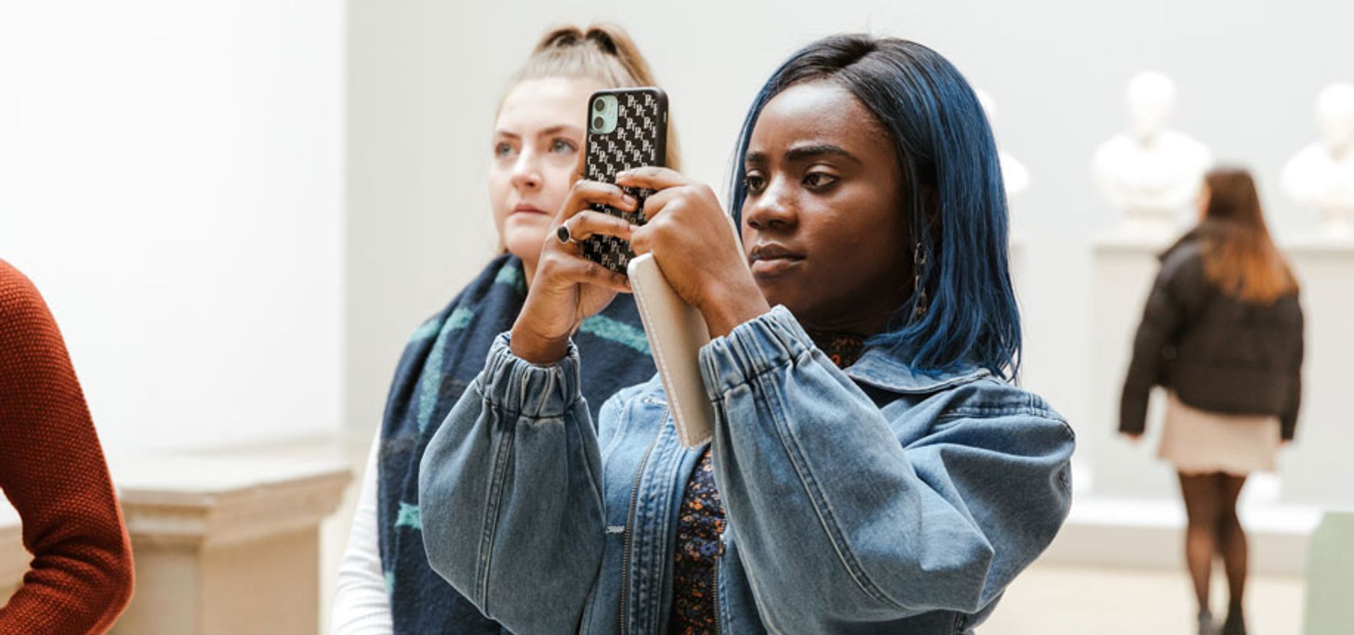 Someone taking a photo of an artwork at Leeds Art Gallery