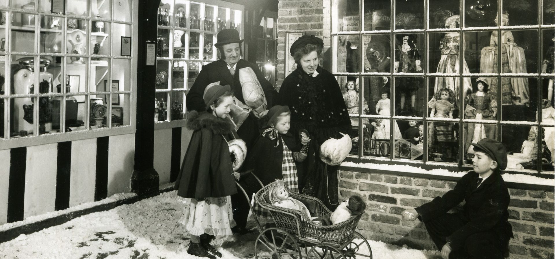 a victorian family window shopping in a street