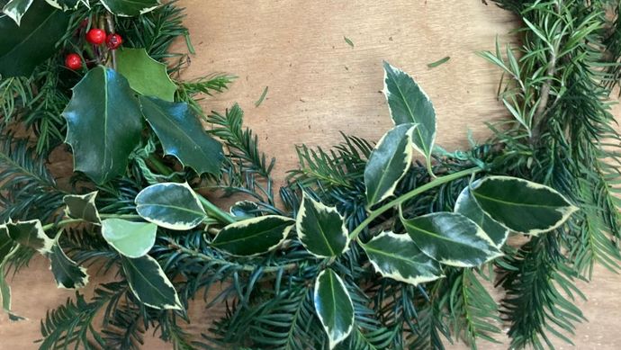 A foraged wreath with holly and fur