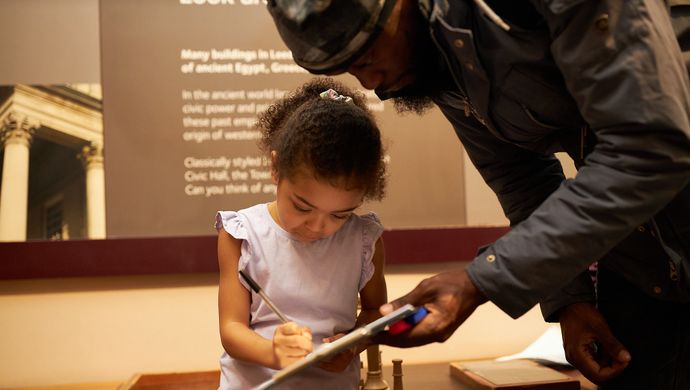 young girl in museum with father