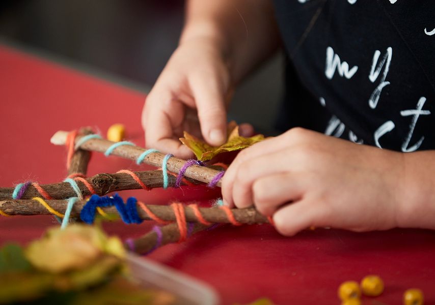 a view of a persons hands and crafting materials 