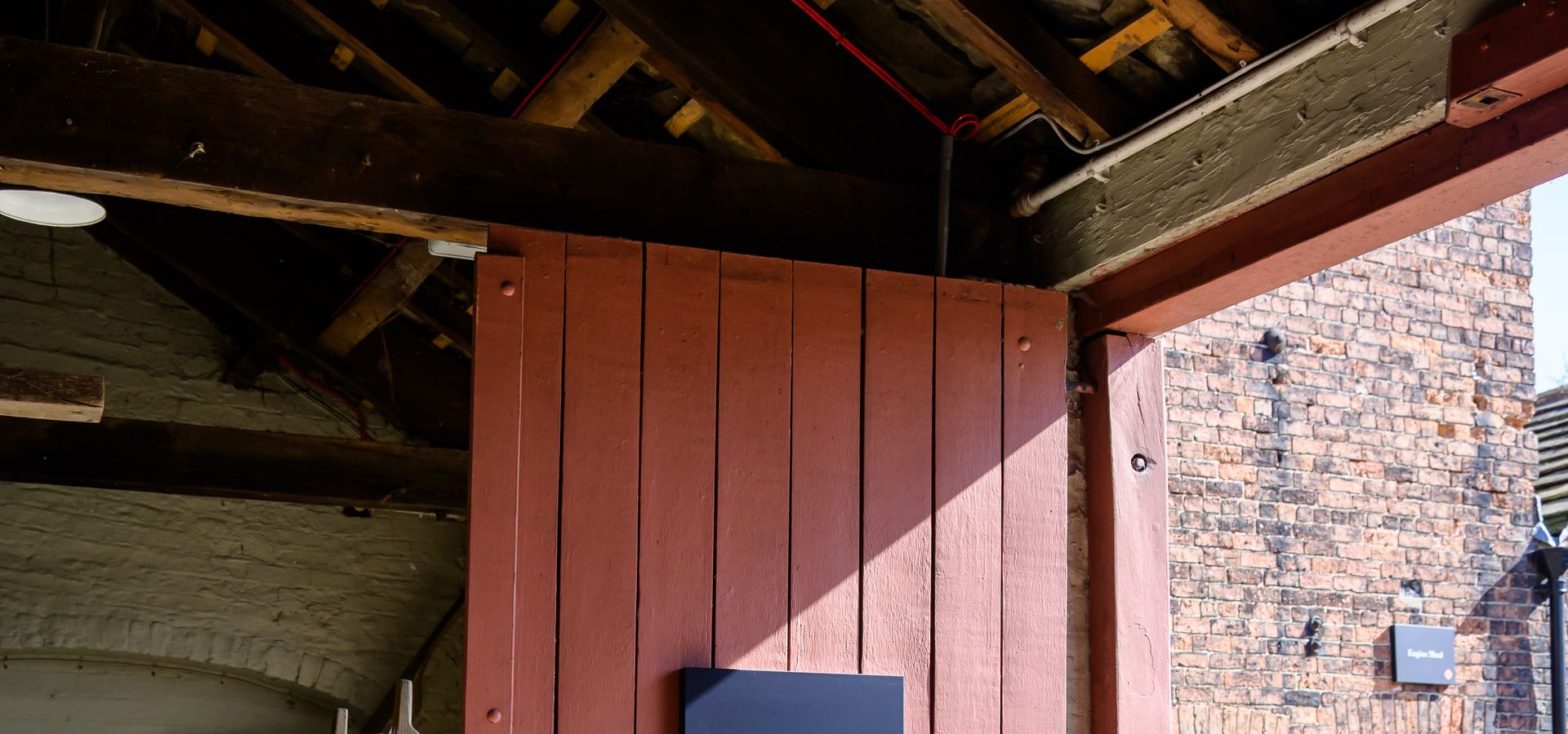 Red door at Home Farm with a sign saying Joiners Shop