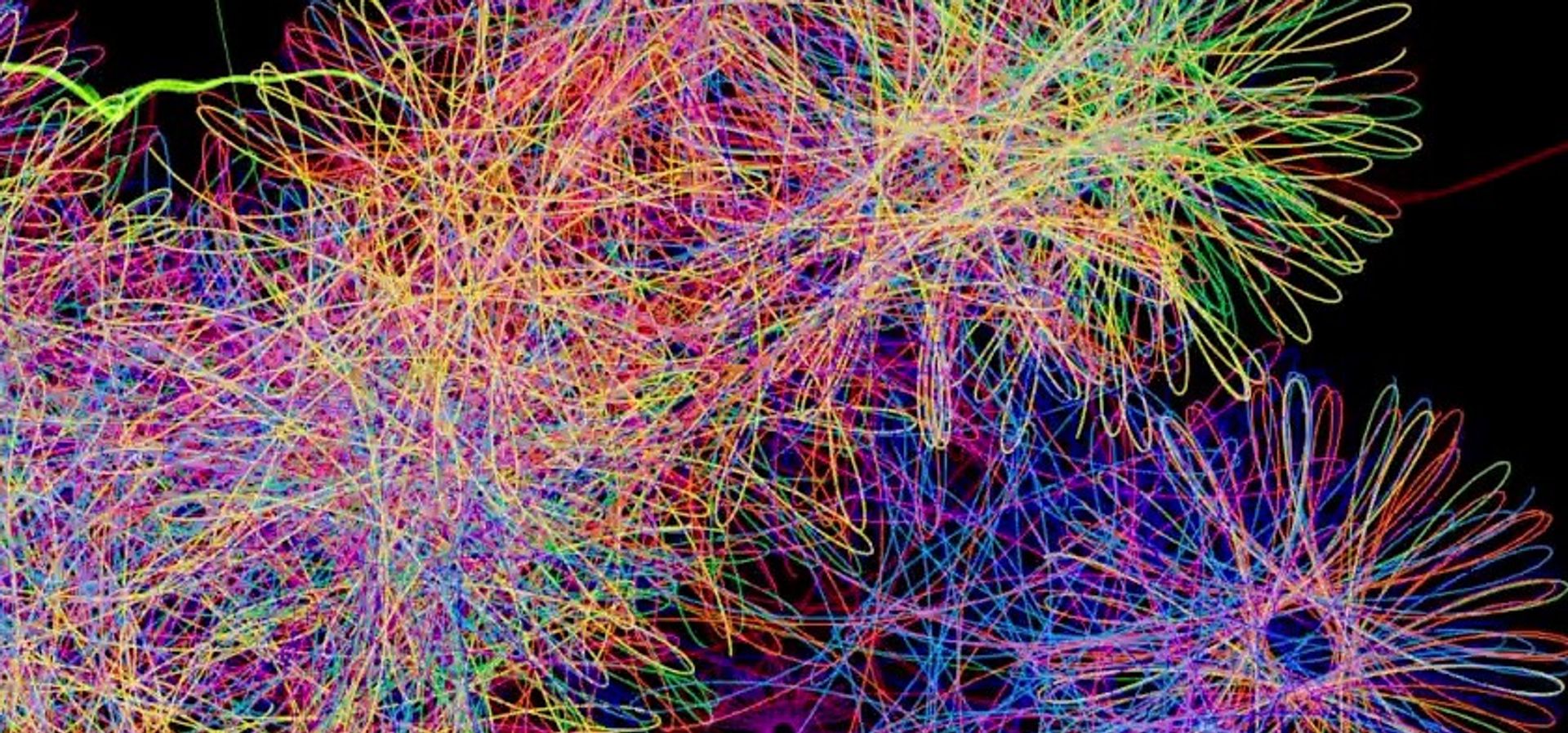 Digital Spirograph drawings in bright colours on a black background