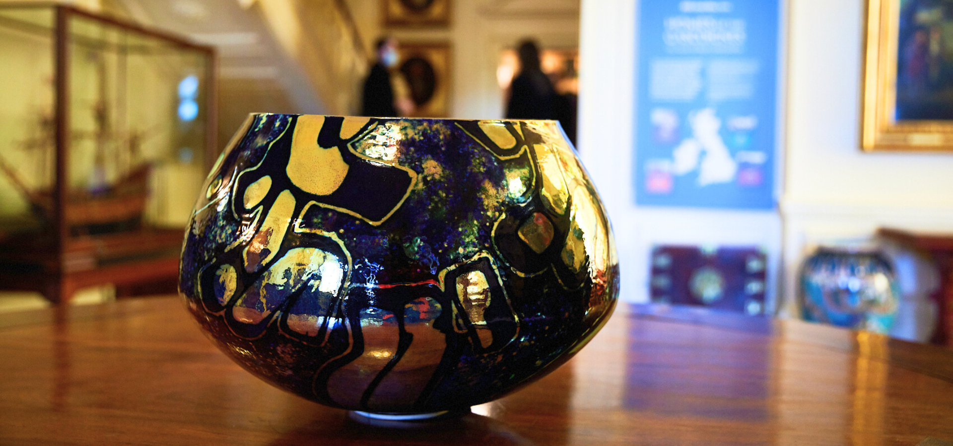 A black and gold bowl on a table in Lotherton Hall