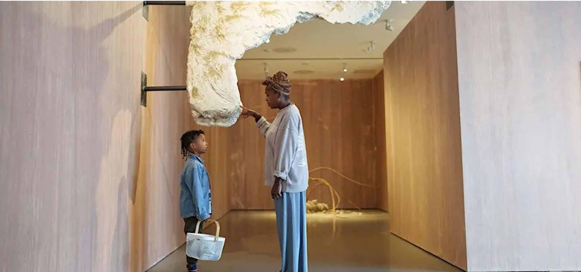 An adult and child looking at sculpture 