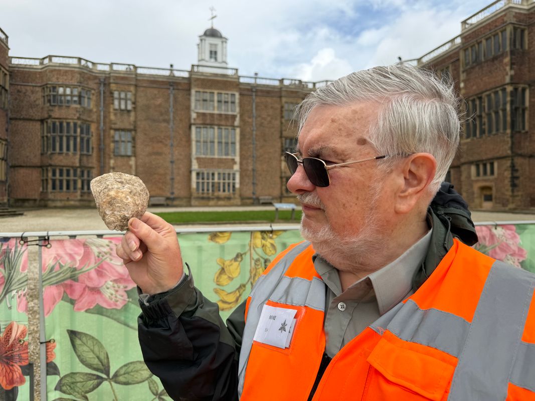 Mike Turpin from South Leeds Archaeology (SLA) holding animal bones and oyster shells from the house’s former kitchens in front of Temple Newsam House