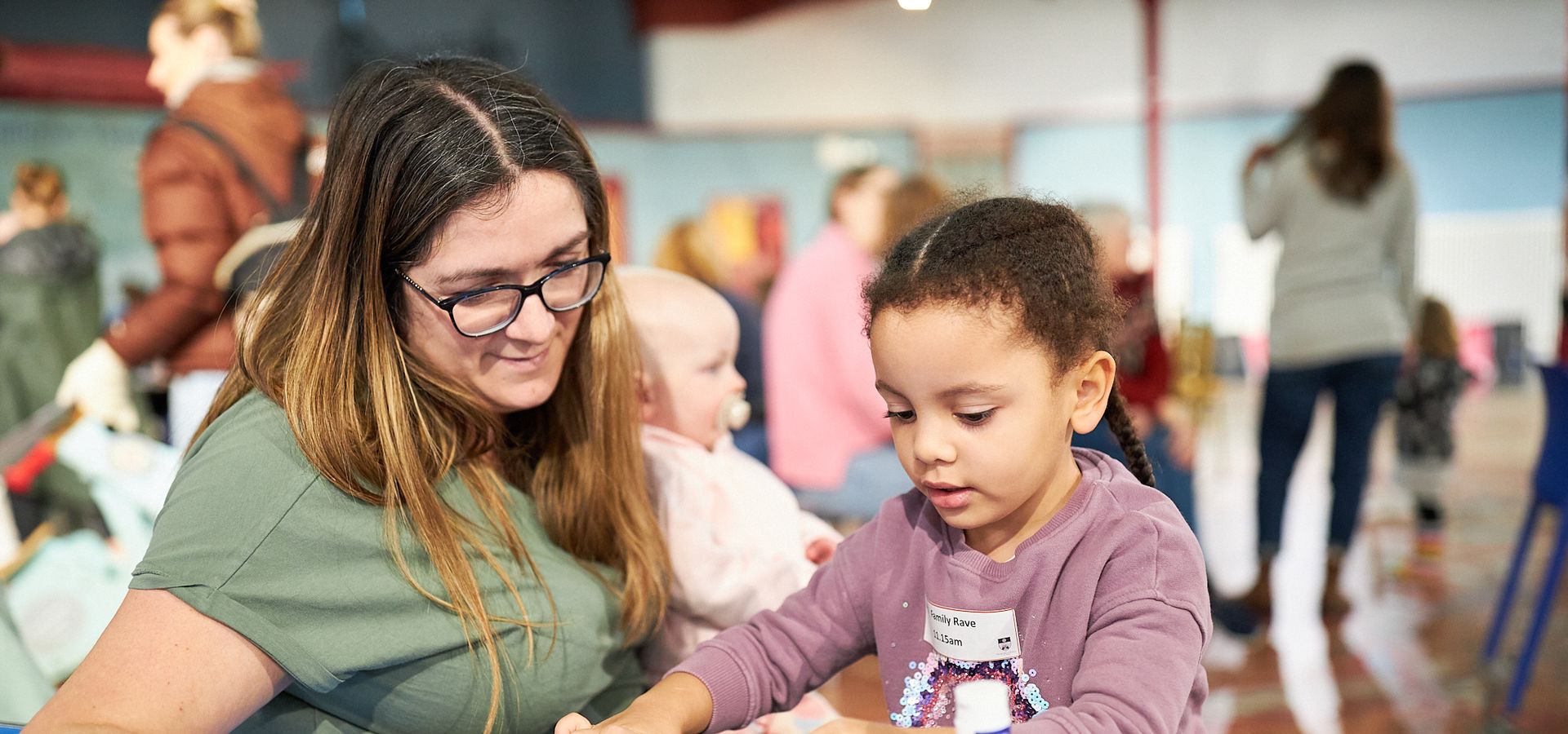 A mum and daughter crafting at a table