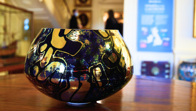 A black and gold bowl on a table in Lotherton Hall
