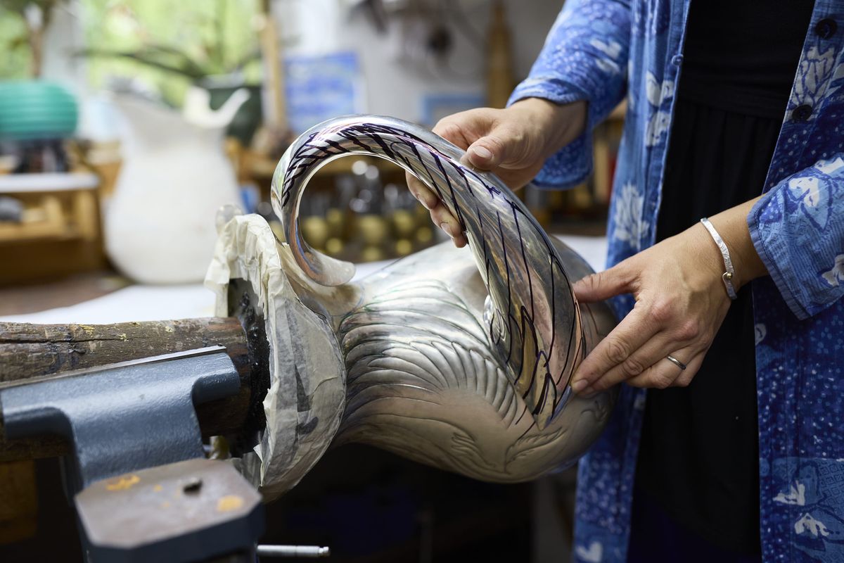 Miriam Handid holding a sample handle of a jug in her studio
