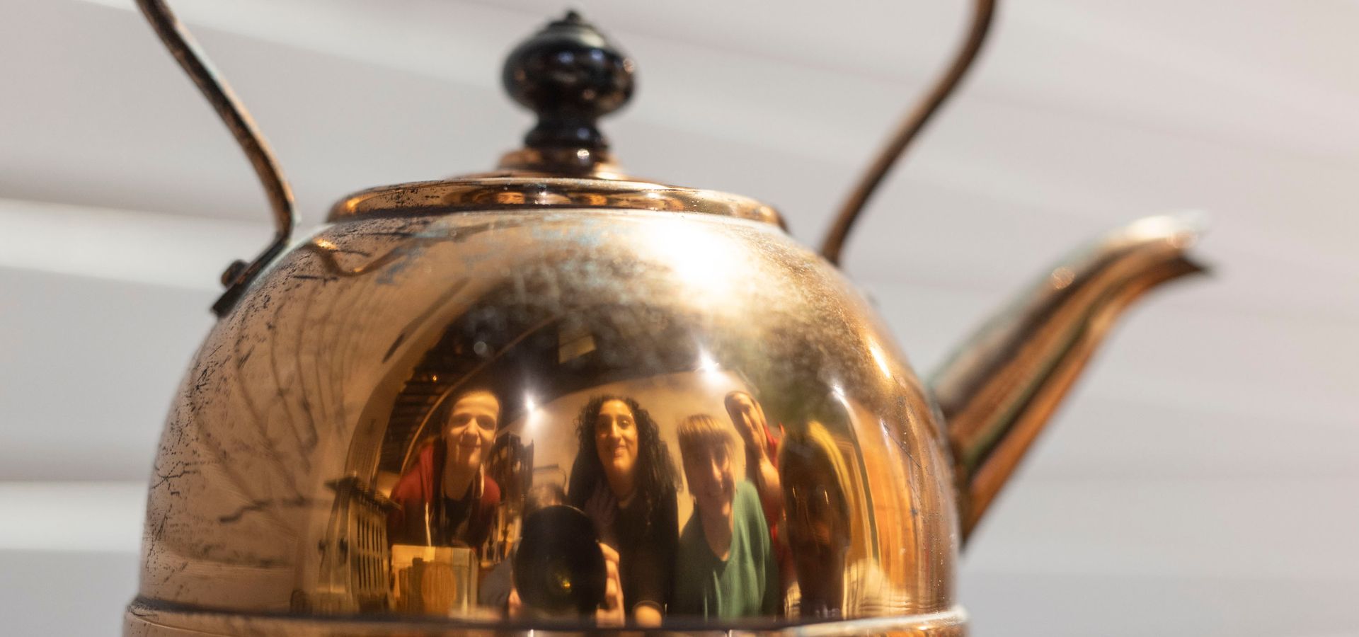 A copper kettle with the reflection of the preservative party in 