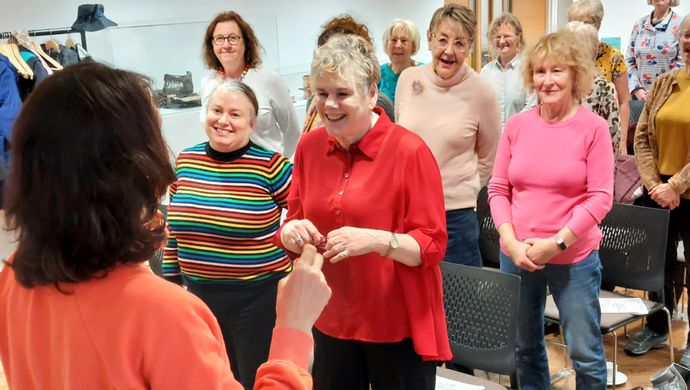 A community group at Leeds City Museum singing as a choir