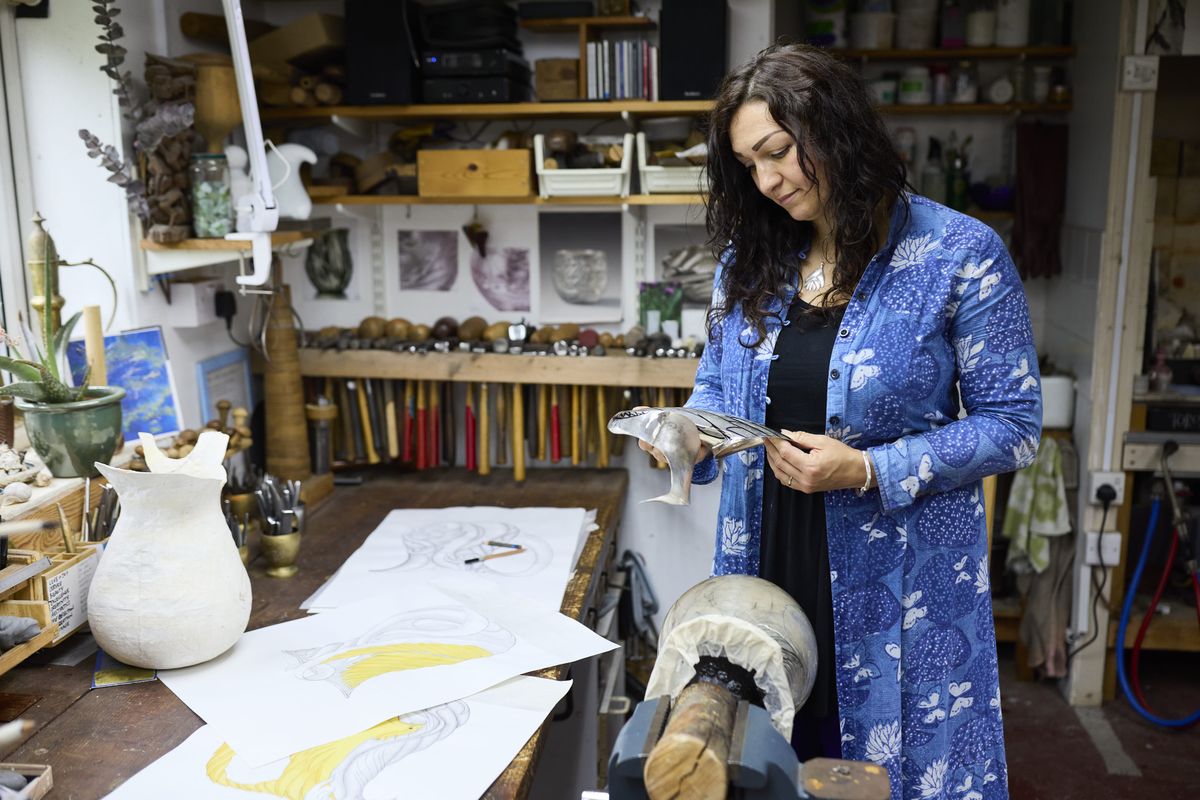 Miriam Handid looking at silver samples in her studio