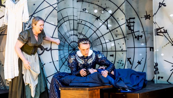 An actor, actress and child performing Romeo and Juliet