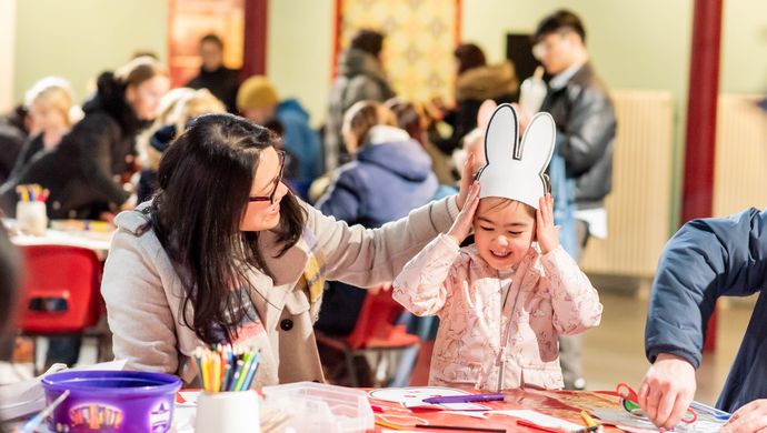 A young girl and parent doing crafts at Leeds City Museum