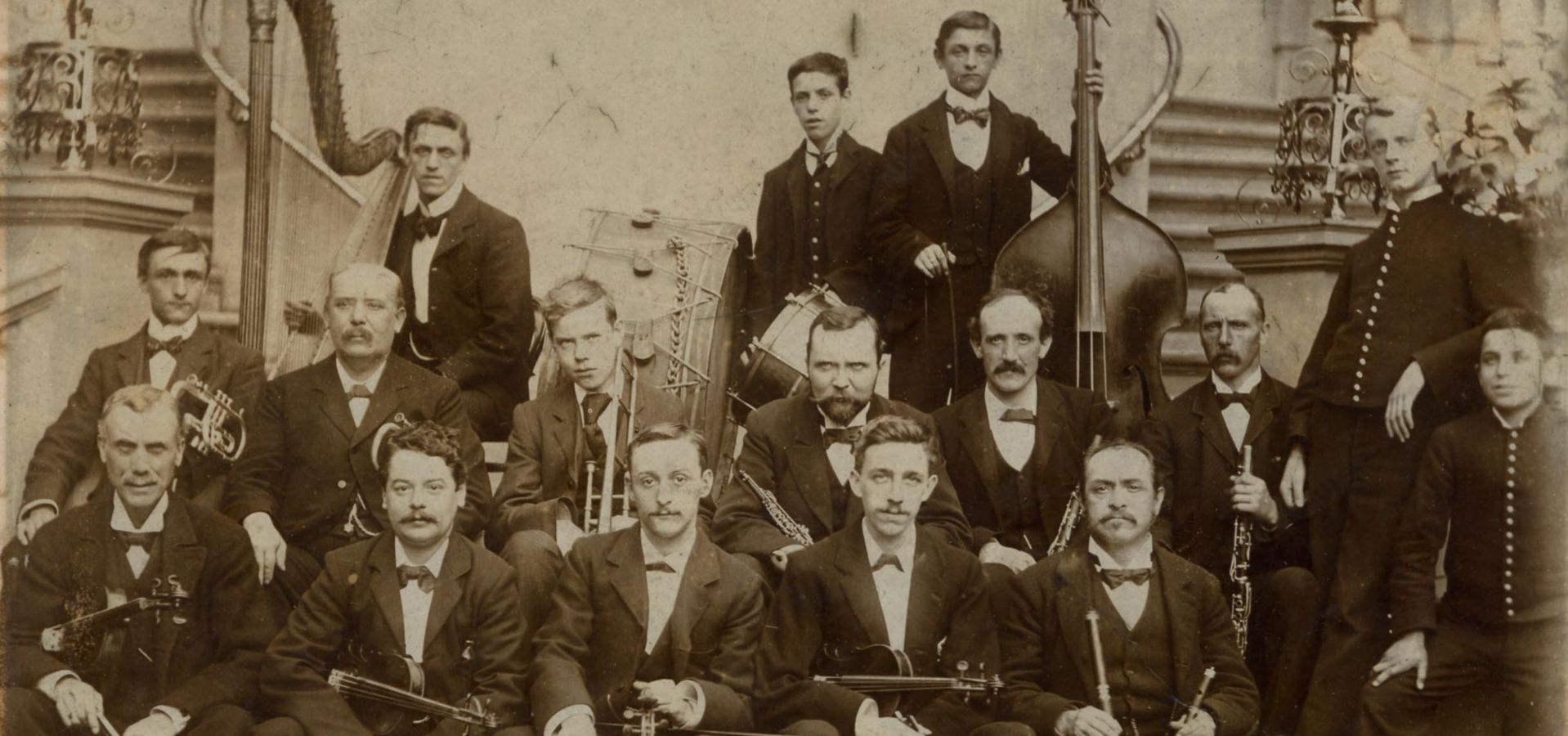 Dearlove band, a group of 16 men in suits and bow ties with orchestral instruments