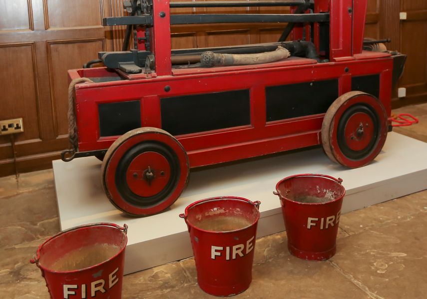 An old house style fire water tank and buckets