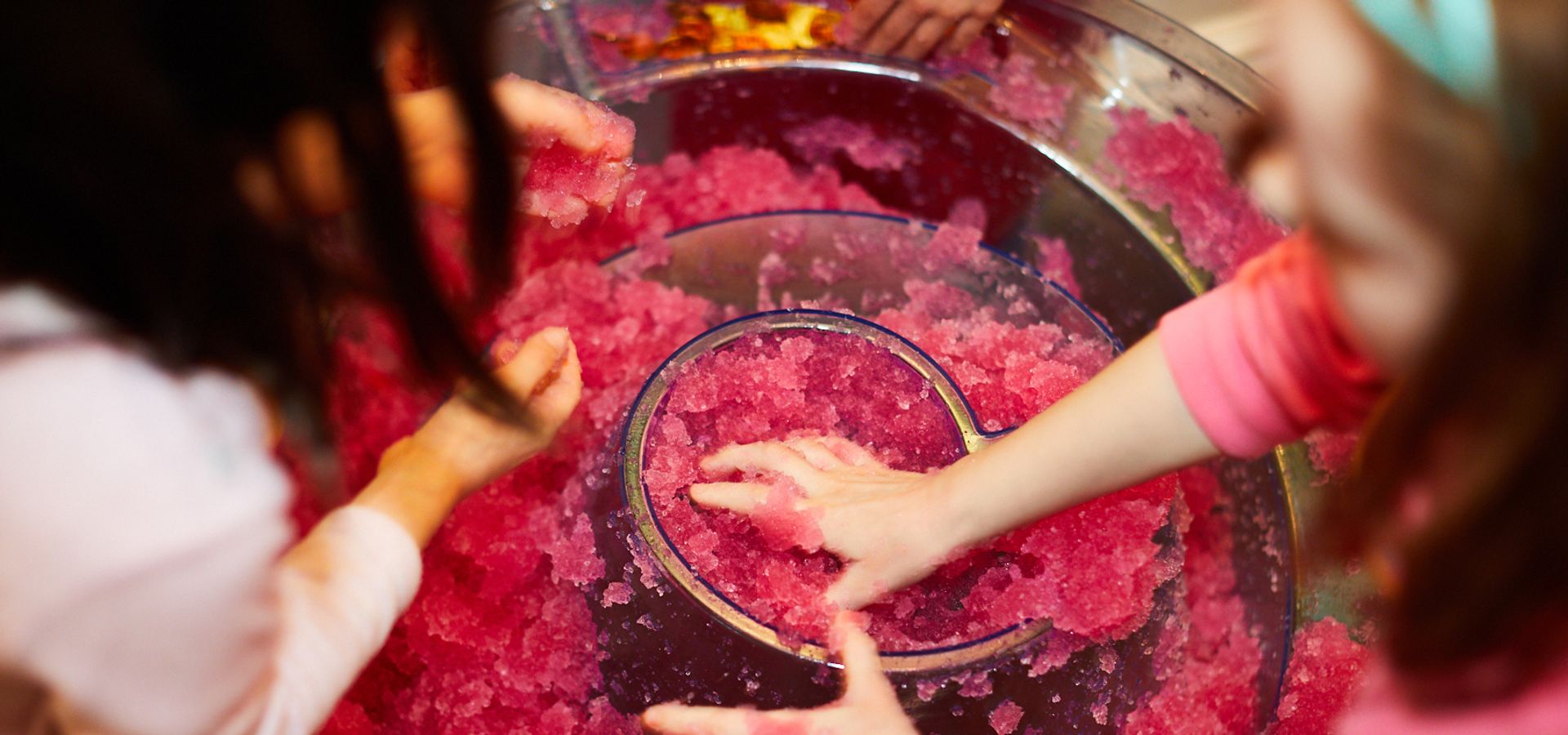 Children playing with a red goo activity