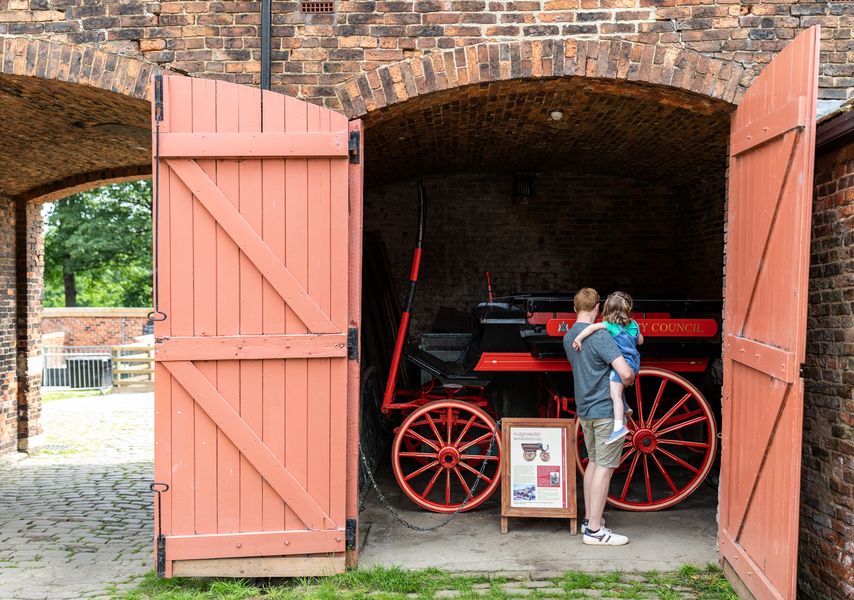 A father and child explore Home Farm at Temple Newsam.