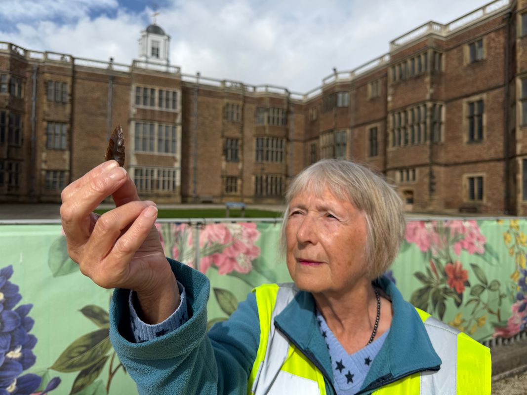 Carole Bloom holding an arrowhead which may be up to 5,000 years old