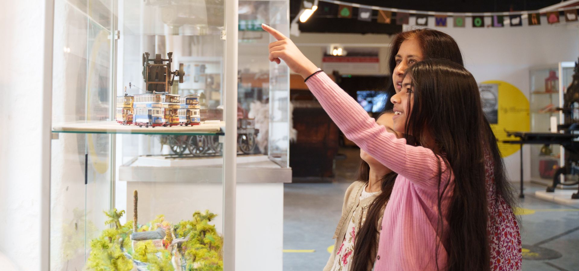 An adult and child looking at a display cabinet at Leeds Industrial Museum