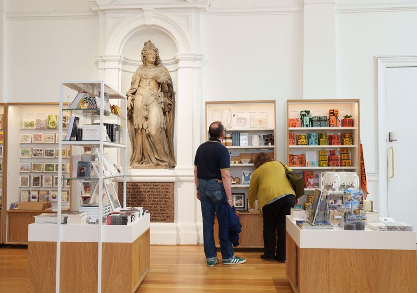 Two adults looking around a shop at Leeds Art Gallery
